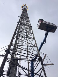 Don't look down: engineers replace lamps on 30m high lighting tower
