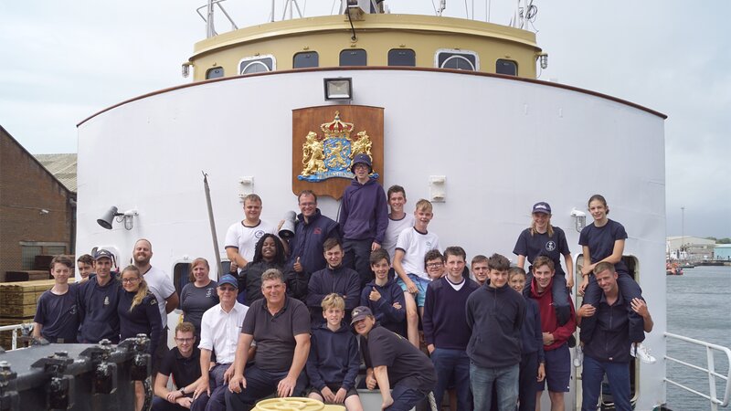The Zeefakkel Crew on their boat at the front.