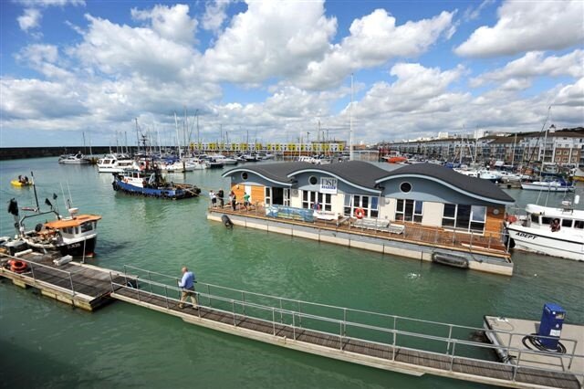 Shoreham Port tug adurni tows new million pound club house for Brighton marina